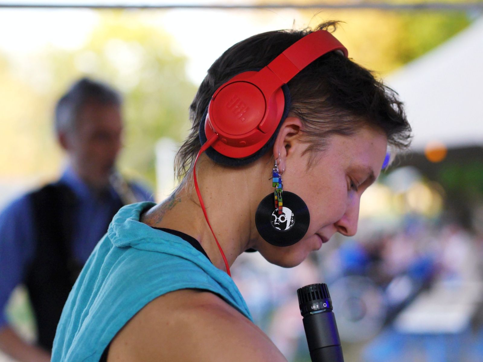 Luca Aza with red headphones and microphone during a live set